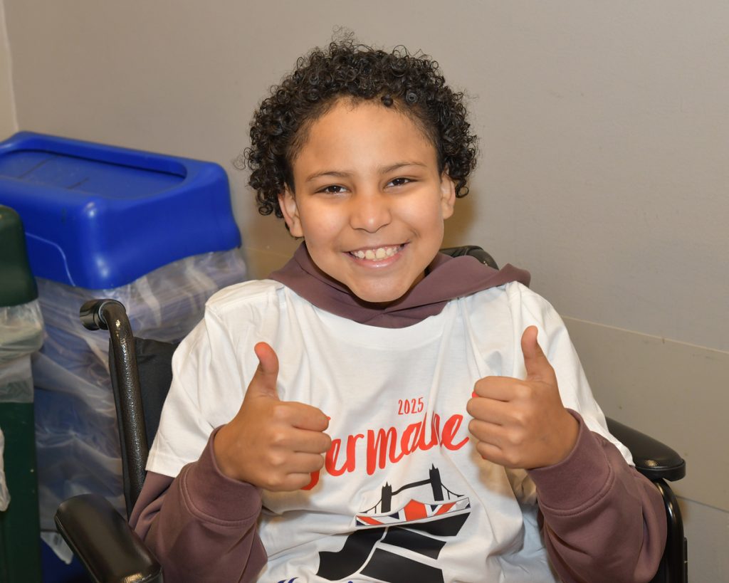 Smiling boy gives thumbs up